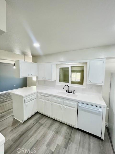 28838 Snead Dr, Menifee, CA 92586 - kitchen with white dishwasher, white cabinets, light countertops, and light wood-style flooring