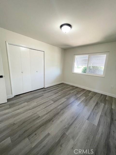 28838 Snead Dr, Menifee, CA 92586 - unfurnished bedroom featuring wood finished floors and a closet