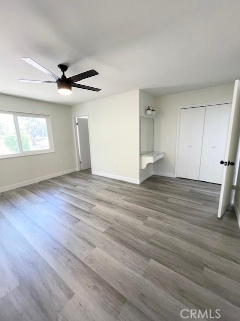 28838 Snead Dr, Menifee, CA 92586 - unfurnished living room with ceiling fan and wood finished floors