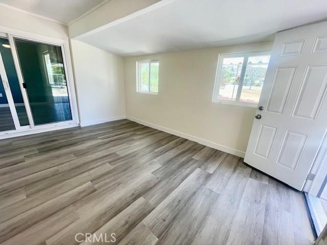 28838 Snead Dr, Menifee, CA 92586 - spare room with wood finished floors and baseboards