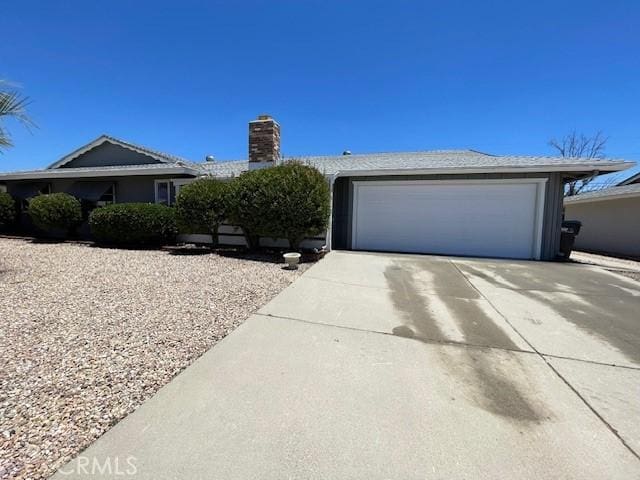 28838 Snead Dr, Menifee, CA 92586 - single story home featuring concrete driveway, a chimney, and an attached garage