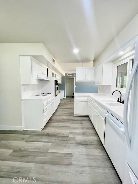 28838 Snead Dr, Menifee, CA 92586 - kitchen featuring white appliances, white cabinets, light countertops, and light wood-type flooring