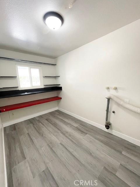 28838 Snead Dr, Menifee, CA 92586 - laundry room featuring wood finished floors and baseboards
