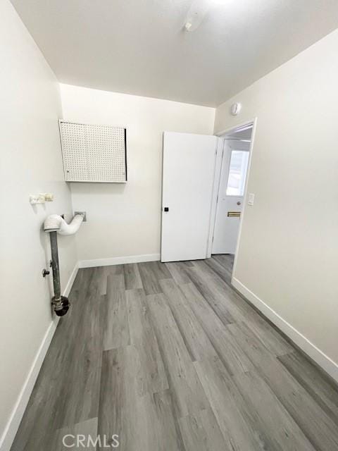 28838 Snead Dr, Menifee, CA 92586 - laundry area with wood finished floors and baseboards