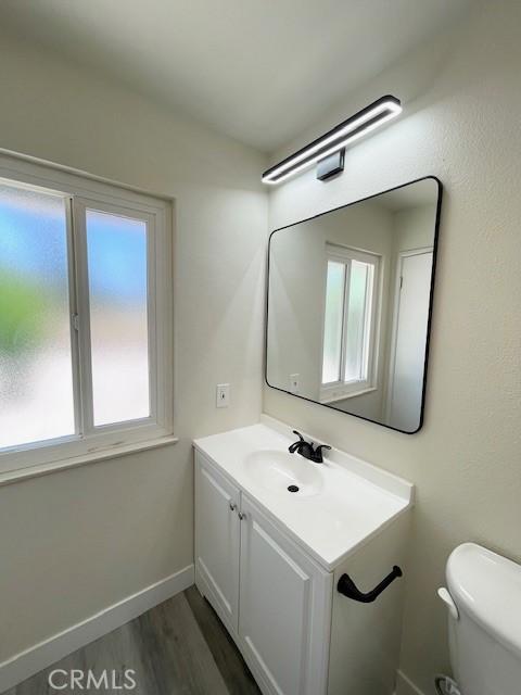28838 Snead Dr, Menifee, CA 92586 - bathroom featuring vanity, healthy amount of natural light, and wood finished floors
