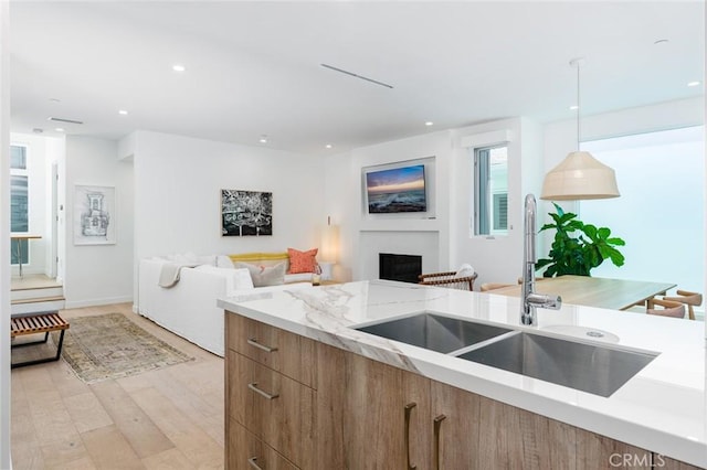 6191/2 Marguerite, Corona Del Mar, CA 92625 - kitchen featuring modern cabinets, open floor plan, a fireplace, light stone countertops, and light wood-style floors