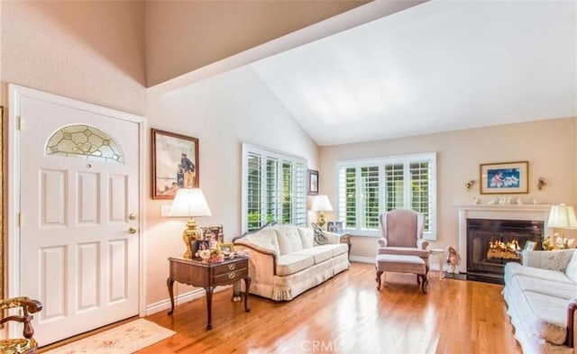 856 Ardmore Cir, Redlands, CA 92374 - foyer featuring wood finished floors, high vaulted ceiling, and a fireplace with flush hearth