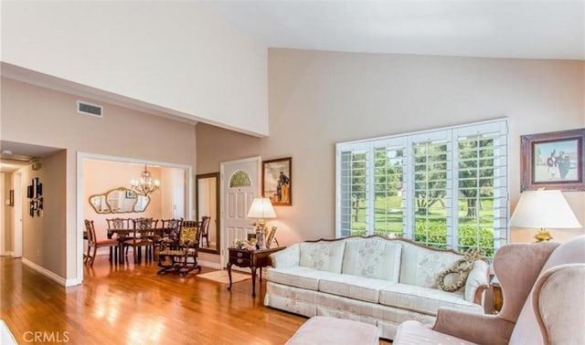 856 Ardmore Cir, Redlands, CA 92374 - living room featuring wood finished floors, a chandelier, and high vaulted ceiling