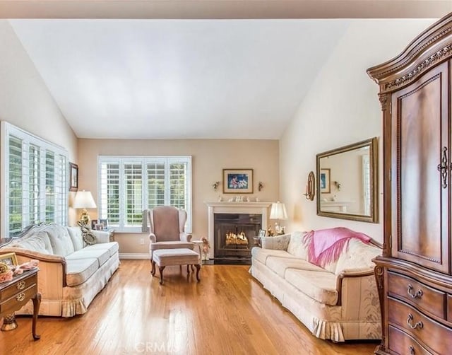 856 Ardmore Cir, Redlands, CA 92374 - living room with lofted ceiling, light wood-type flooring, and a fireplace with flush hearth