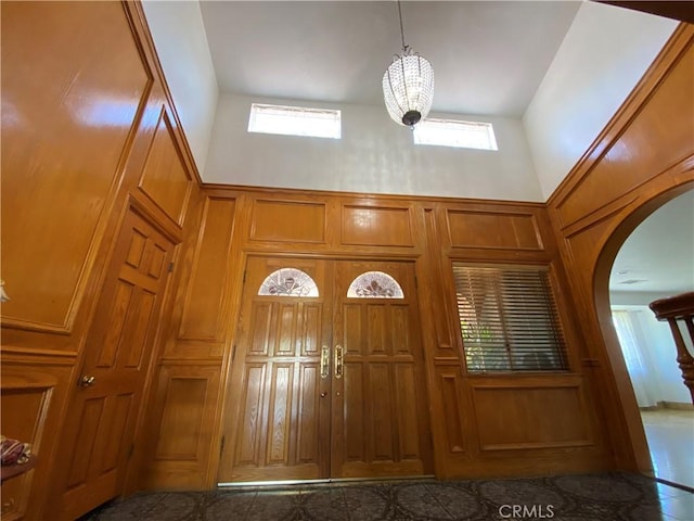 13761 Lomitas Ave, La Puente, CA 91746 - entryway with arched walkways, healthy amount of natural light, a towering ceiling, a chandelier, and a decorative wall