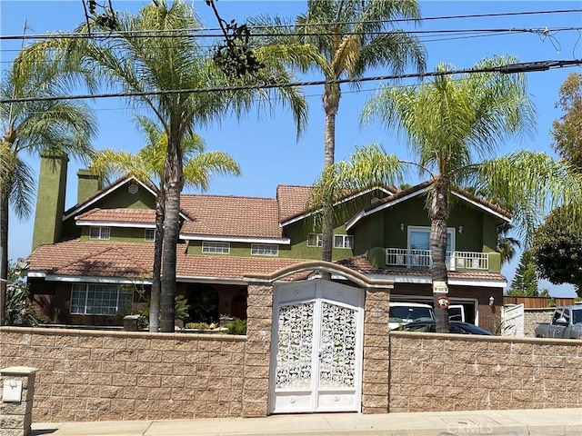 13761 Lomitas Ave, La Puente, CA 91746 - view of front of house with a fenced front yard, a balcony, and a tiled roof