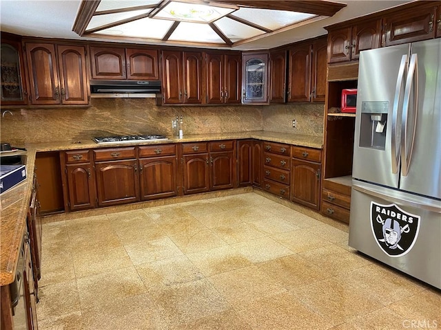 13761 Lomitas Ave, La Puente, CA 91746 - kitchen with stainless steel appliances, under cabinet range hood, tasteful backsplash, glass insert cabinets, and light stone counters