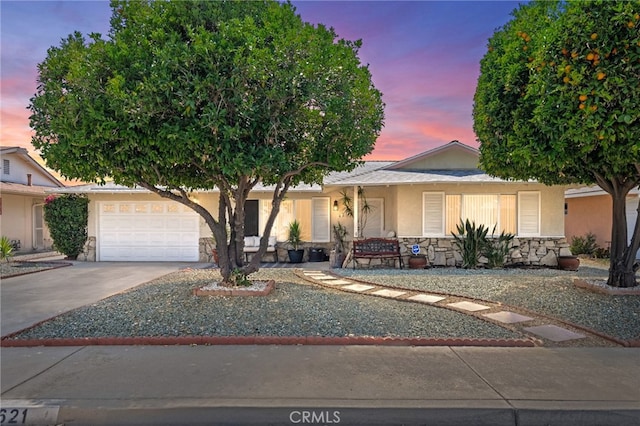 621 Shasta Way, Hemet, CA 92543 - view of front of property with a garage, driveway, stone siding, stucco siding, and a porch