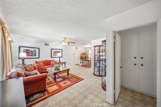 621 Shasta Way, Hemet, CA 92543 - living area featuring a ceiling fan, light colored carpet, and a textured ceiling