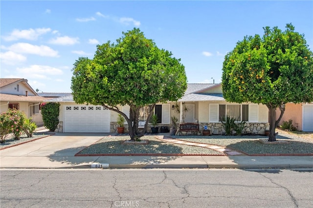 621 Shasta Way, Hemet, CA 92543 - view of front of home with a garage, concrete driveway, stucco siding, stone siding, and covered porch