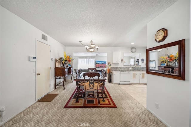 621 Shasta Way, Hemet, CA 92543 - dining room featuring a chandelier, a textured ceiling, and light colored carpet