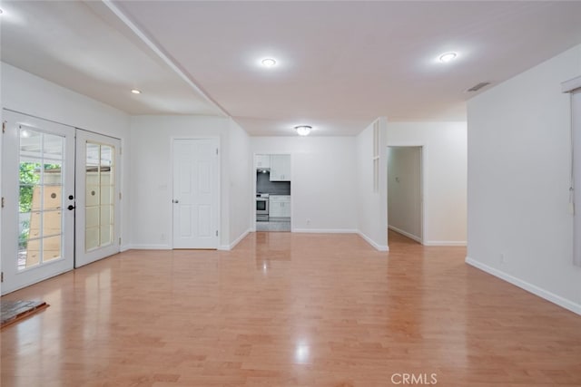 16908 Los Alimos St, Granada Hills, CA 91344 - unfurnished living room featuring light wood-style floors, french doors, and recessed lighting