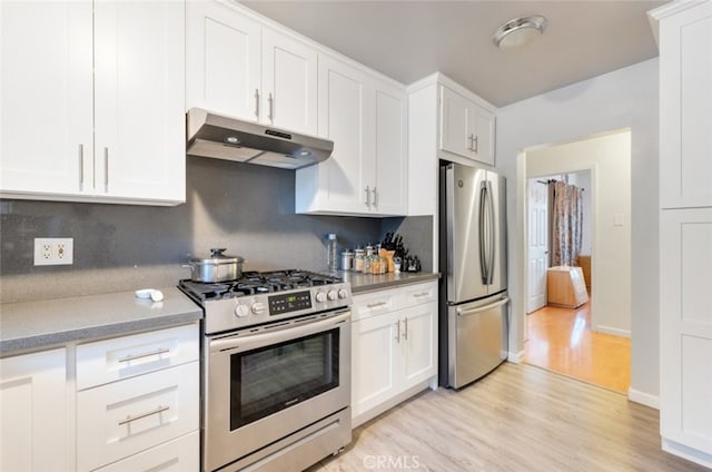 16908 Los Alimos St, Granada Hills, CA 91344 - kitchen with stainless steel appliances, under cabinet range hood, light wood-style flooring, white cabinetry, and light countertops