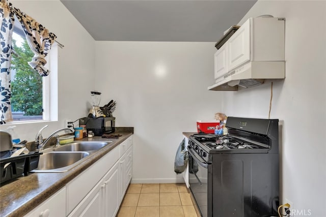 16908 Los Alimos St, Granada Hills, CA 91344 - kitchen with gas stove, white cabinets, light tile patterned flooring, under cabinet range hood, and dark countertops