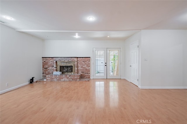 16908 Los Alimos St, Granada Hills, CA 91344 - unfurnished living room featuring wood finished floors, french doors, and a brick fireplace