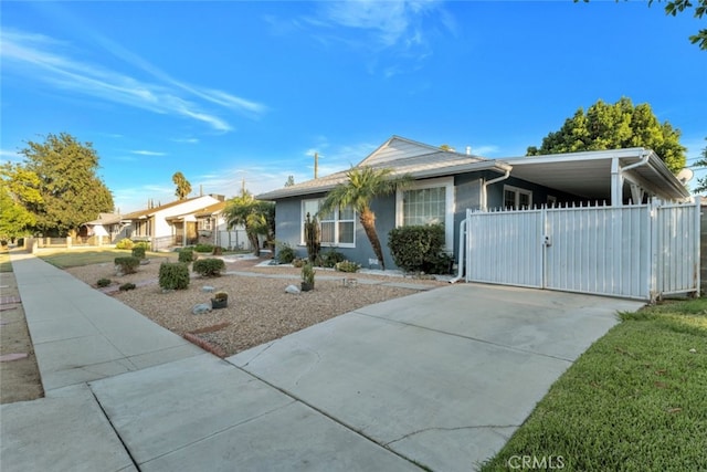 16908 Los Alimos St, Granada Hills, CA 91344 - ranch-style home with driveway, a gate, a carport, and stucco siding