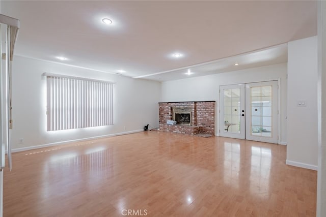 16908 Los Alimos St, Granada Hills, CA 91344 - unfurnished living room featuring light wood finished floors, recessed lighting, french doors, and a fireplace