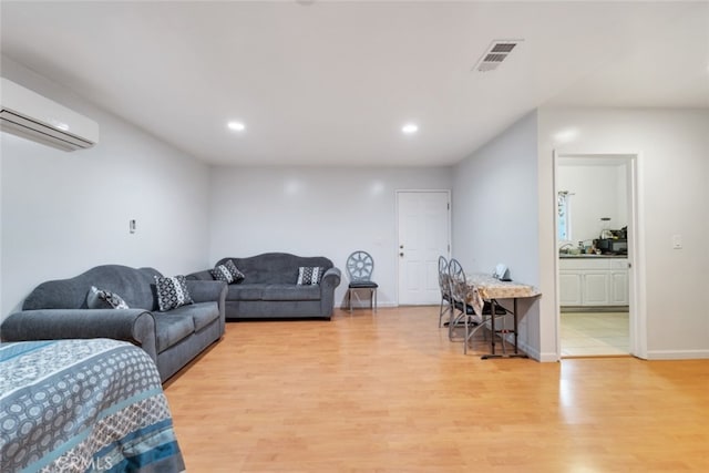 16908 Los Alimos St, Granada Hills, CA 91344 - living area with an AC wall unit, light wood-style flooring, and recessed lighting