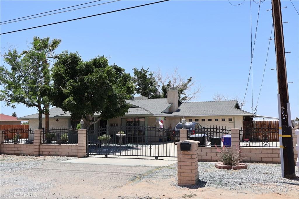 12386 Pawnee Rd, Apple Valley, CA 92308 - view of front facade featuring a fenced front yard and a chimney