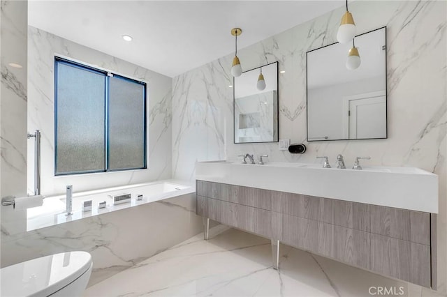 20500 Blairmoore St, Chatsworth, CA 91311 - bathroom with double vanity, a garden tub, marble tiled floors, and stone wall