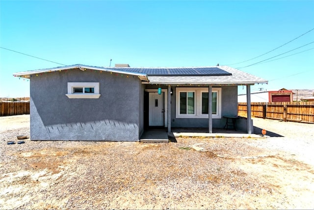 29246 Radio Rd, Barstow, CA 92311 - ranch-style house with solar panels, stucco siding, and a fenced backyard