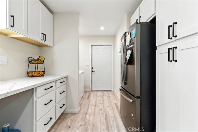29246 Radio Rd, Barstow, CA 92311 - kitchen featuring freestanding refrigerator, light wood finished floors, white cabinetry, light stone counters, and recessed lighting