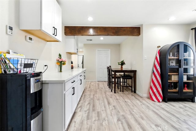 29246 Radio Rd, Barstow, CA 92311 - kitchen with light wood-style floors, light countertops, white cabinets, beam ceiling, and recessed lighting