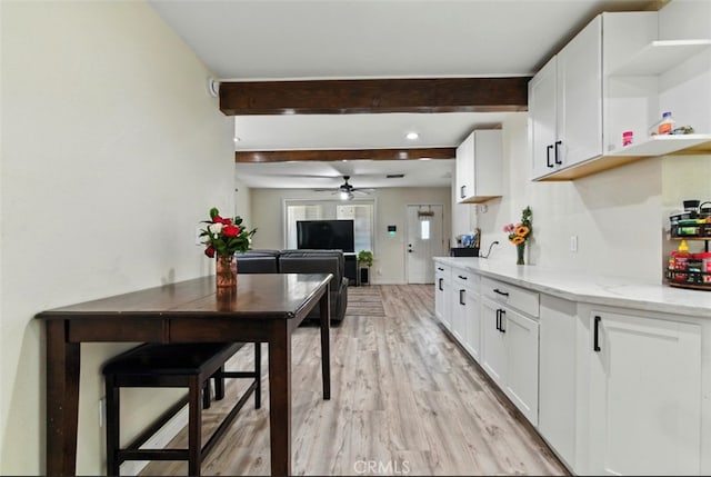 29246 Radio Rd, Barstow, CA 92311 - kitchen featuring open shelves, a ceiling fan, beam ceiling, light stone countertops, and light wood-style flooring
