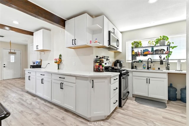 29246 Radio Rd, Barstow, CA 92311 - kitchen with appliances with stainless steel finishes, open shelves, white cabinets, light wood finished floors, and recessed lighting