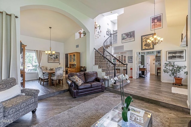 4665 Northridge Dr, Palmdale, CA 93551 - living room featuring a chandelier, stairway, arched walkways, high vaulted ceiling, and wood finished floors