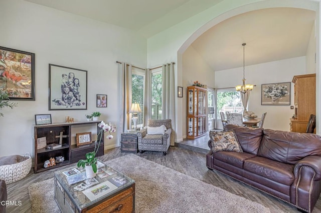 4665 Northridge Dr, Palmdale, CA 93551 - living area featuring arched walkways, a chandelier, wood finished floors, and high vaulted ceiling
