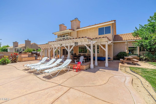 4665 Northridge Dr, Palmdale, CA 93551 - rear view of house with a pergola, a patio area, a chimney, and stucco siding