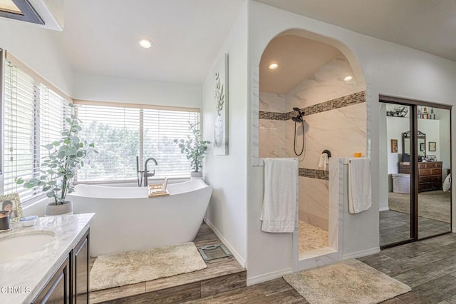 4665 Northridge Dr, Palmdale, CA 93551 - full bath with a freestanding tub, walk in shower, wood finished floors, recessed lighting, and vanity