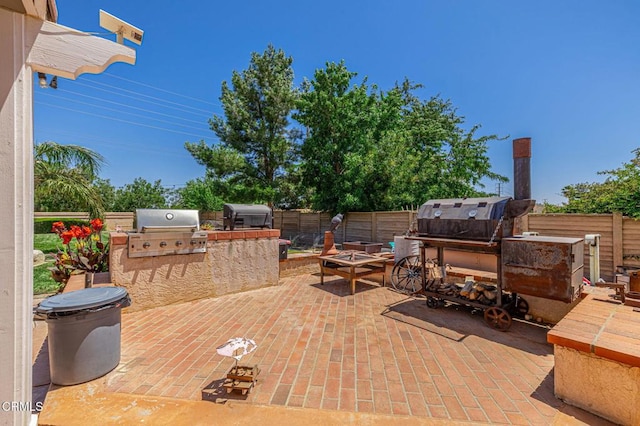 4665 Northridge Dr, Palmdale, CA 93551 - fenced backyard featuring area for grilling, a patio area, and a fire pit