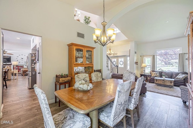 4665 Northridge Dr, Palmdale, CA 93551 - dining room with a chandelier, wood finished floors, and a towering ceiling