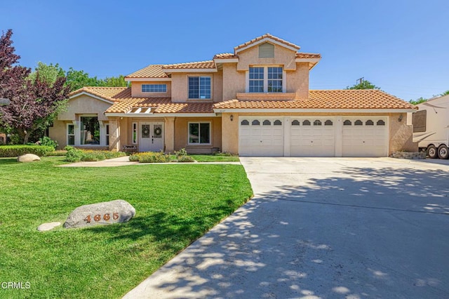4665 Northridge Dr, Palmdale, CA 93551 - mediterranean / spanish home featuring concrete driveway, stucco siding, a front lawn, an attached garage, and a tile roof