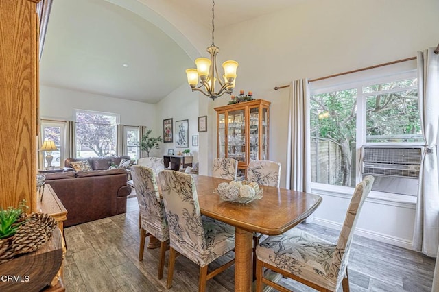 4665 Northridge Dr, Palmdale, CA 93551 - dining area featuring a chandelier, wood finished floors, plenty of natural light, and high vaulted ceiling