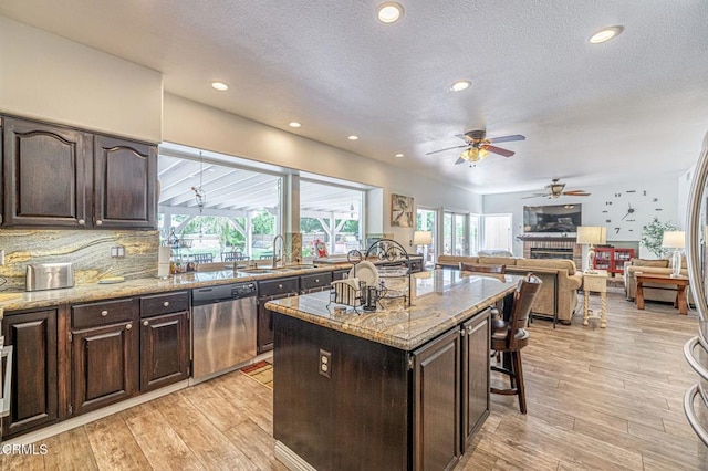 4665 Northridge Dr, Palmdale, CA 93551 - kitchen featuring dishwasher, ceiling fan, light wood finished floors, dark brown cabinetry, and a fireplace