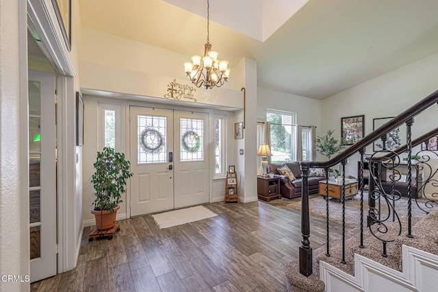 4665 Northridge Dr, Palmdale, CA 93551 - foyer entrance with dark wood finished floors, a chandelier, and stairs