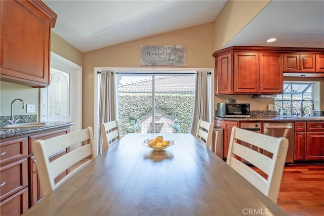 25532 Maximus St, Mission Viejo, CA 92675 - kitchen featuring appliances with stainless steel finishes, lofted ceiling, wood finished floors, recessed lighting, and brown cabinetry