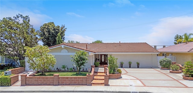 25532 Maximus St, Mission Viejo, CA 92675 - view of front of house with concrete driveway, a tiled roof, and stucco siding