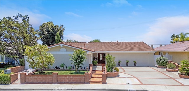 25532 Maximus St, Mission Viejo, CA 92675 - view of front facade with concrete driveway, a tiled roof, and stucco siding