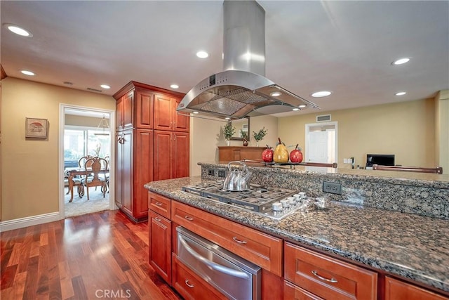 25532 Maximus St, Mission Viejo, CA 92675 - kitchen featuring a warming drawer, island range hood, stainless steel gas cooktop, dark wood-style flooring, and dark stone counters