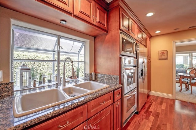 25532 Maximus St, Mission Viejo, CA 92675 - kitchen with wood finished floors, appliances with stainless steel finishes, recessed lighting, and brown cabinetry