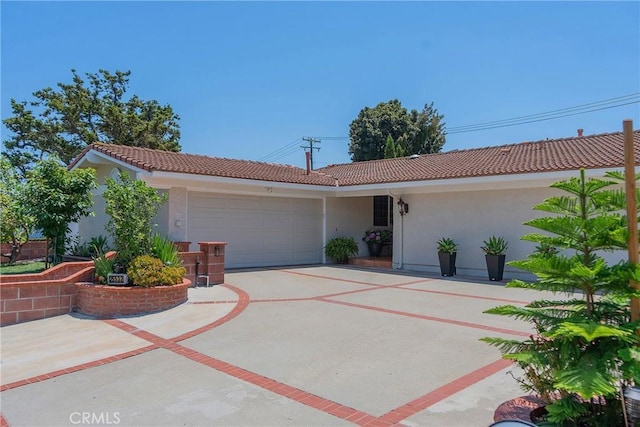 25532 Maximus St, Mission Viejo, CA 92675 - view of front of home with a tile roof, stucco siding, an attached garage, and driveway